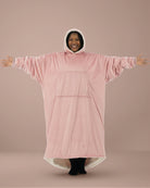Woman wearing The Comfy Original Long in blush with arms extended to show full oversized width and relaxed fit.