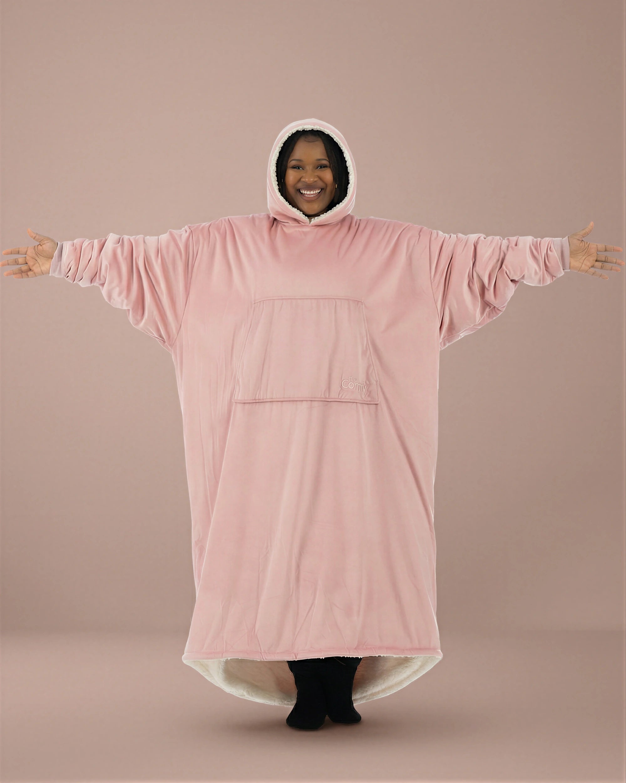 Woman wearing The Comfy Original Long in blush with arms extended to show full oversized width and relaxed fit.