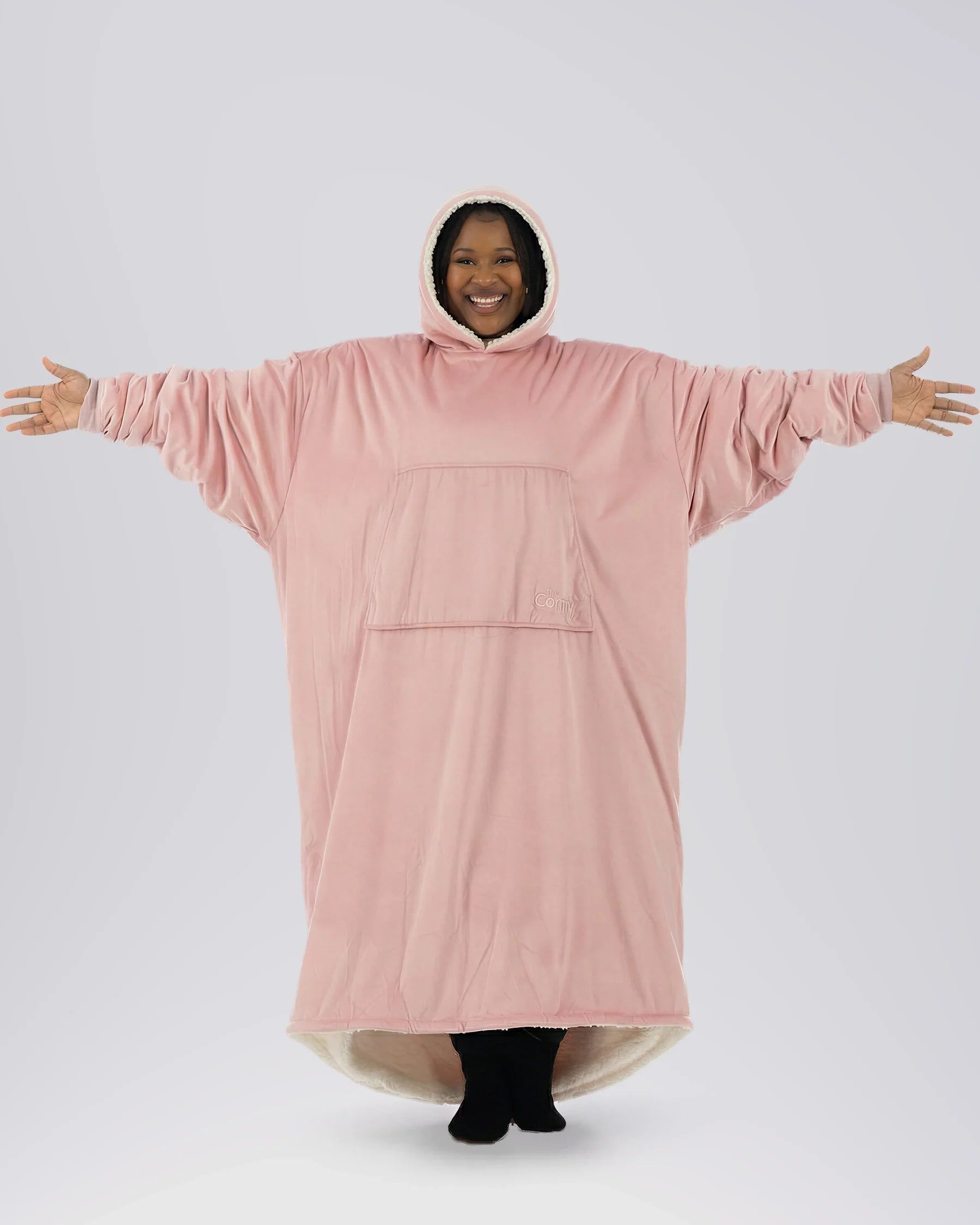 Woman wearing The Comfy Original Long in blush with arms extended to show full oversized width and relaxed fit.