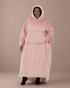 Woman wearing The Comfy Original Long in blush, casual front view with hood up and hand in kangaroo pocket.