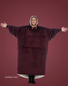 Woman wearing The Comfy Original Long in burgundy with CloudSherpa™ lining, arms extended to show oversized fit.