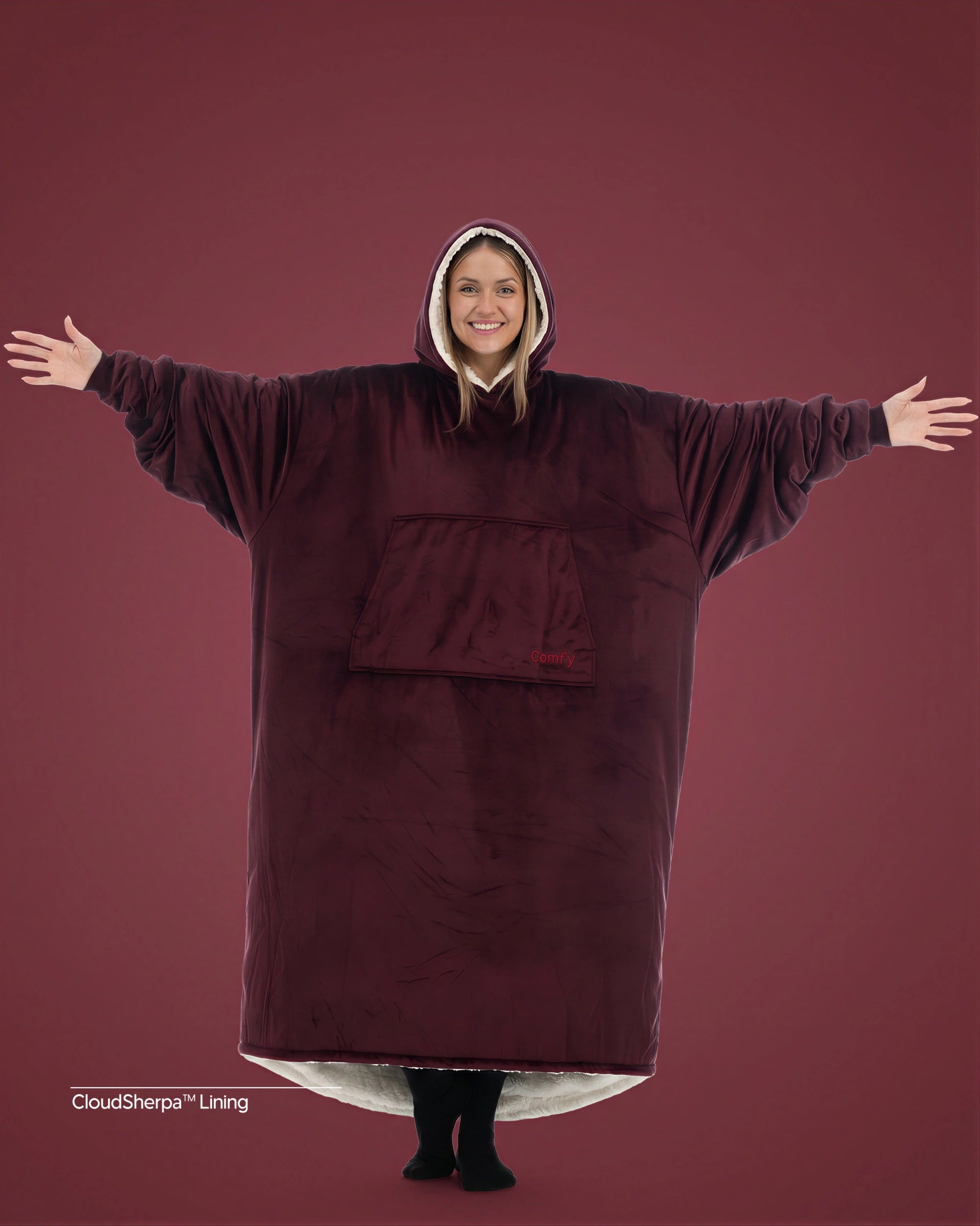 Woman wearing The Comfy Original Long in burgundy with CloudSherpa™ lining, arms extended to show oversized fit.
