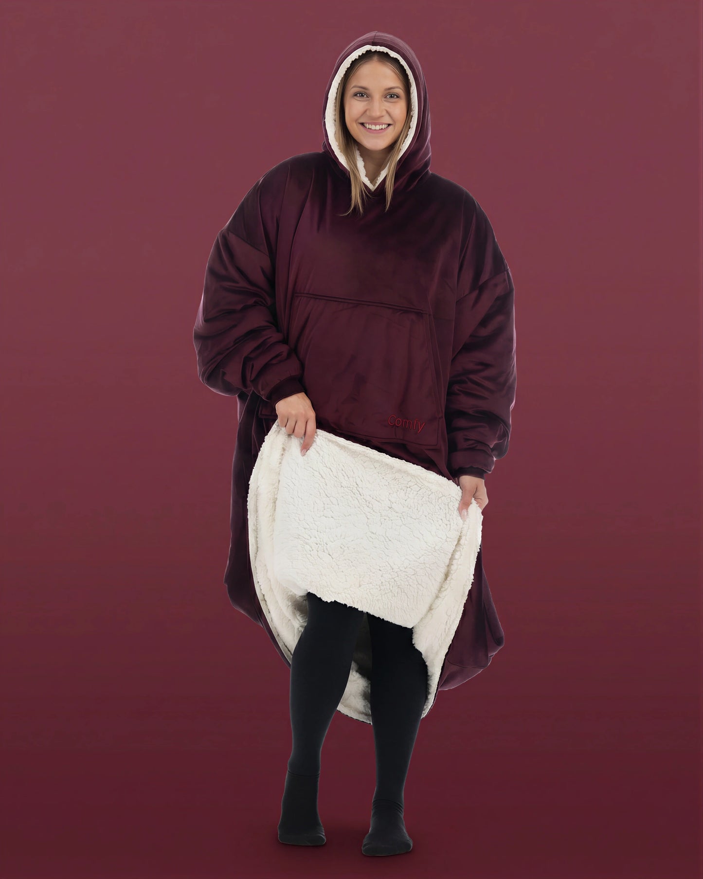Front view of woman wearing The Comfy Original Long in burgundy, lifting hem to reveal CloudSherpa™ lining.