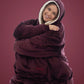 Woman wearing The Comfy Original Long in burgundy, seated comfortably in a relaxed pose.