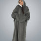 Woman wearing The Comfy Original Long in charcoal in a relaxed standing pose with hood up.