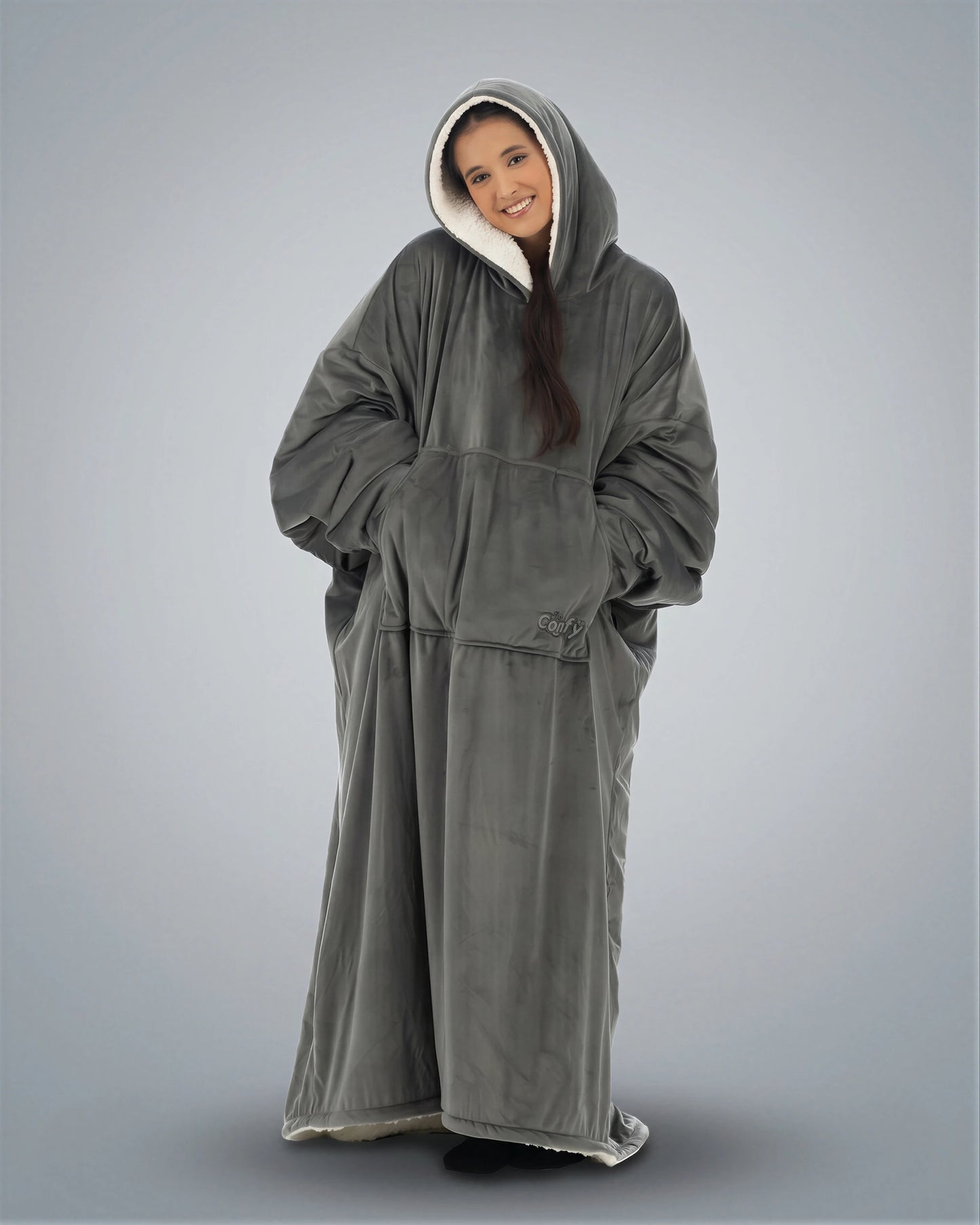 Woman wearing The Comfy Original Long in charcoal in a relaxed standing pose with hood up.