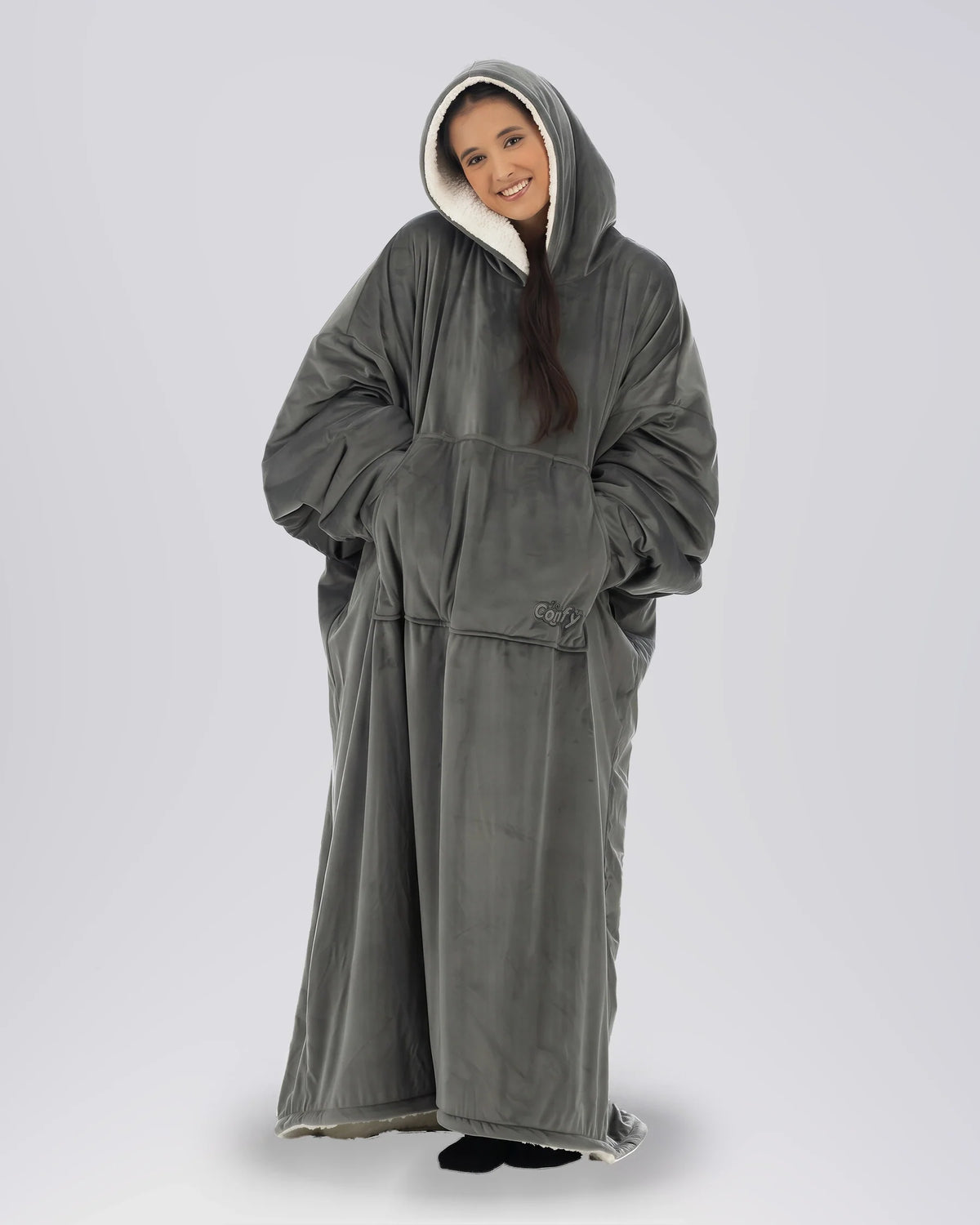 Woman wearing The Comfy Original Long in charcoal in a relaxed standing pose with hood up.