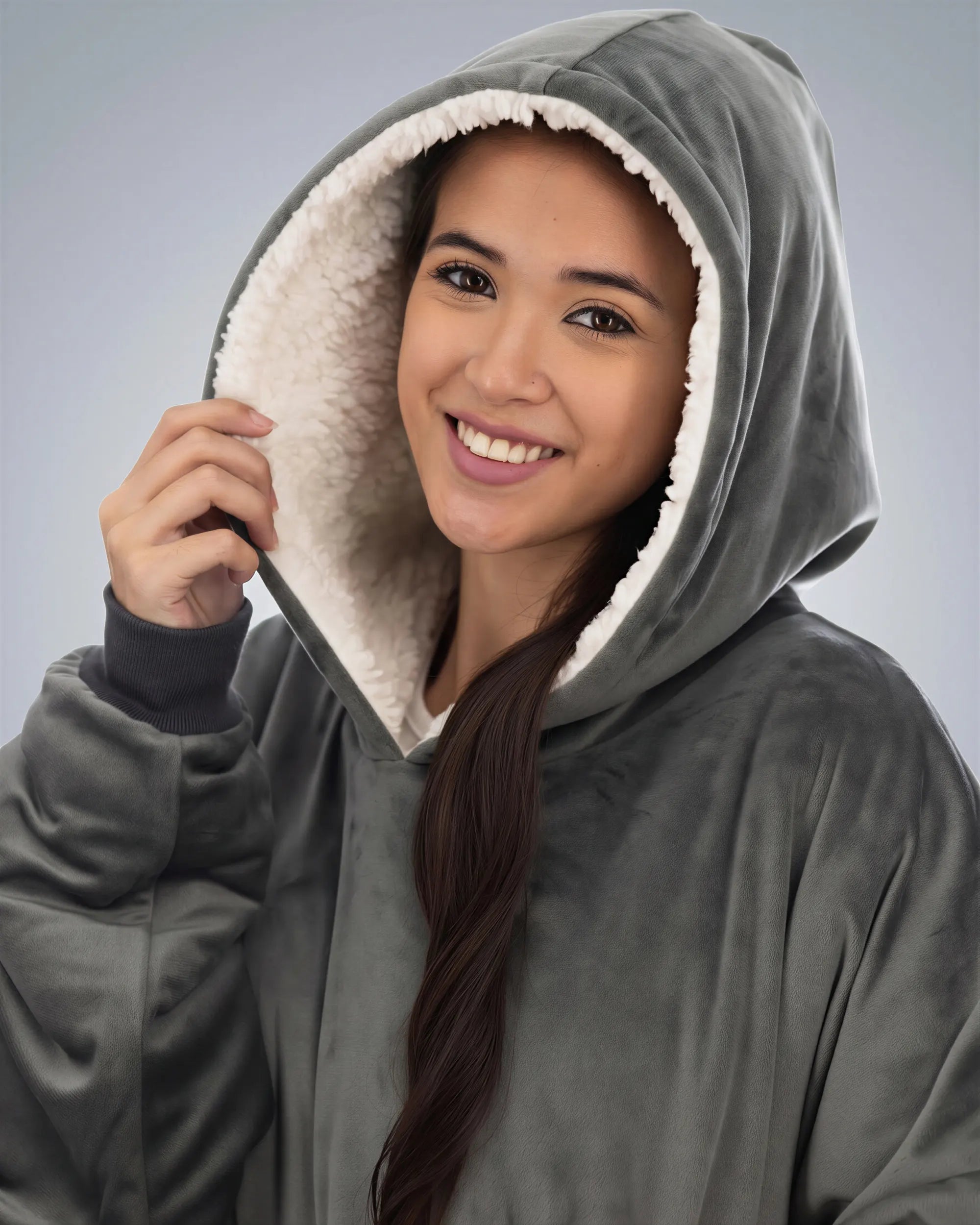 Close-up of woman wearing The Comfy Original Long in charcoal, highlighting hood and CloudSherpa™ lining.