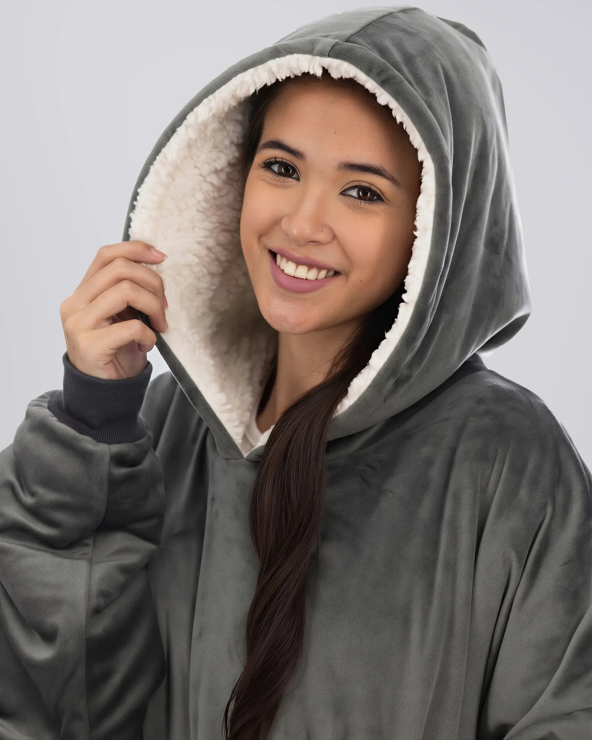 Close-up of woman wearing The Comfy Original Long in charcoal, highlighting hood and CloudSherpa™ lining.