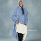 Woman modeling The Original Long in Serenity Blue while revealing the CloudSherpa™ lining, showcasing the extra-long coverage, oversized fit, and signature warmth.