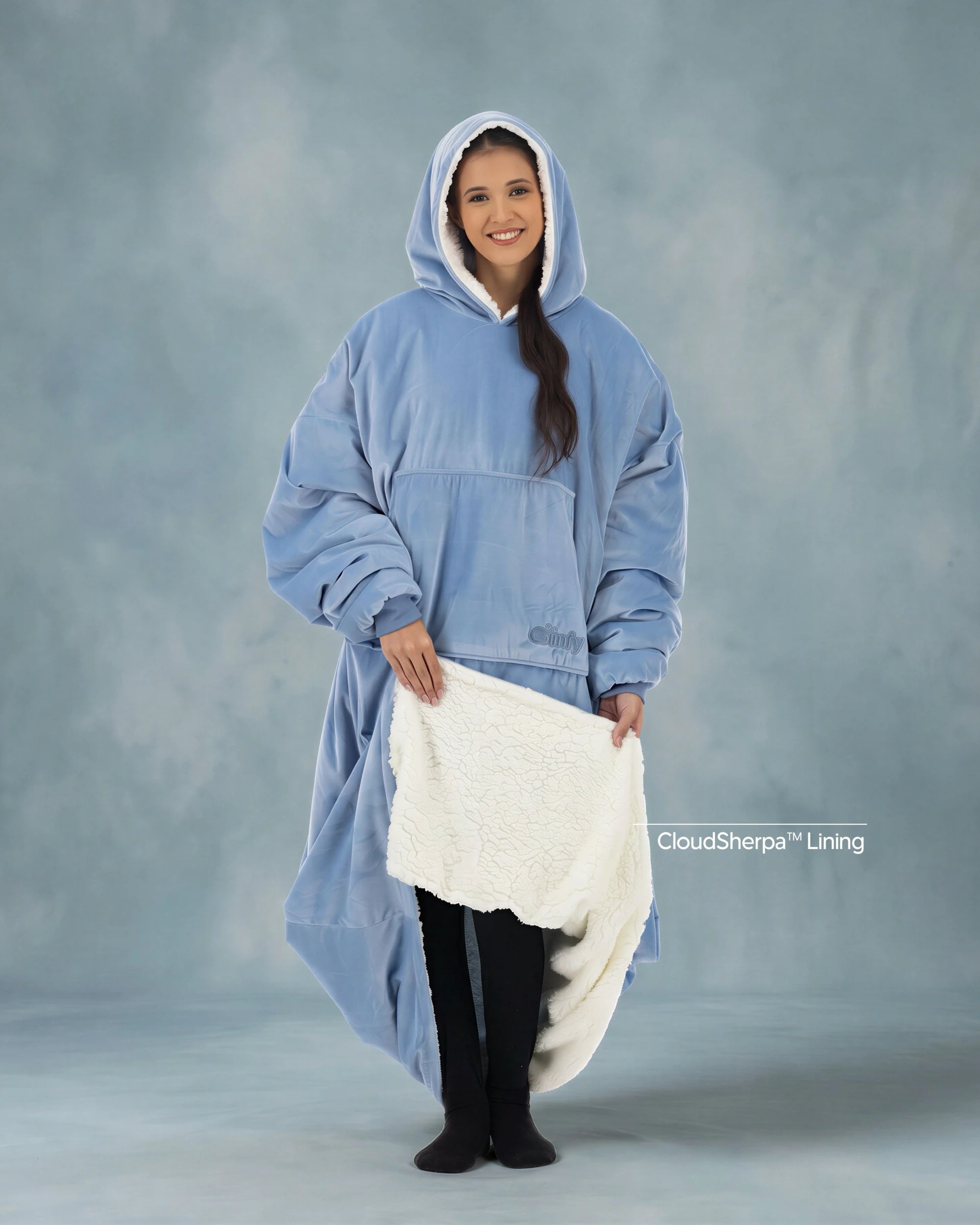 Woman modeling The Original Long in Serenity Blue while revealing the CloudSherpa™ lining, showcasing the extra-long coverage, oversized fit, and signature warmth.