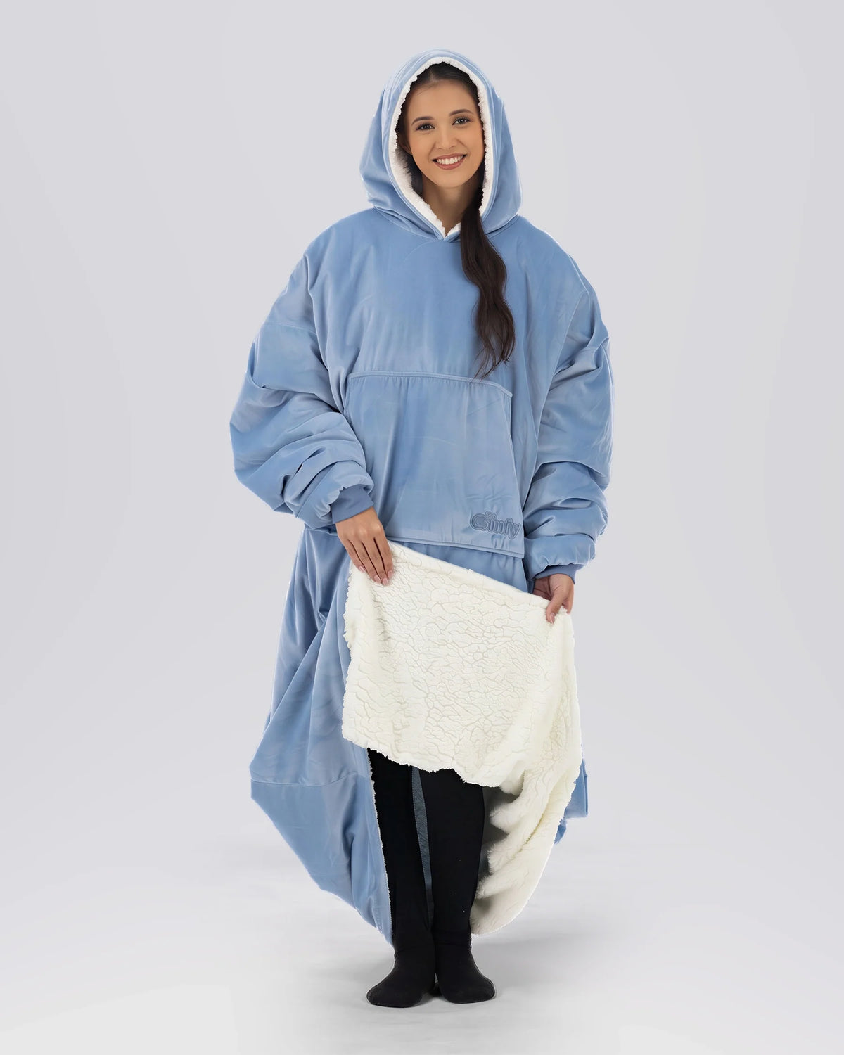 Woman modeling The Original Long in Serenity Blue while revealing the CloudSherpa™ lining, showcasing the extra-long coverage, oversized fit, and signature warmth.
