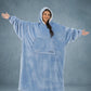 Front view of The Original Long in Serenity Blue with arms extended, highlighting the oversized wearable blanket silhouette, roomy sleeves, and full-body comfort.