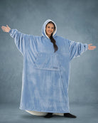 Front view of The Original Long in Serenity Blue with arms extended, highlighting the oversized wearable blanket silhouette, roomy sleeves, and full-body comfort.