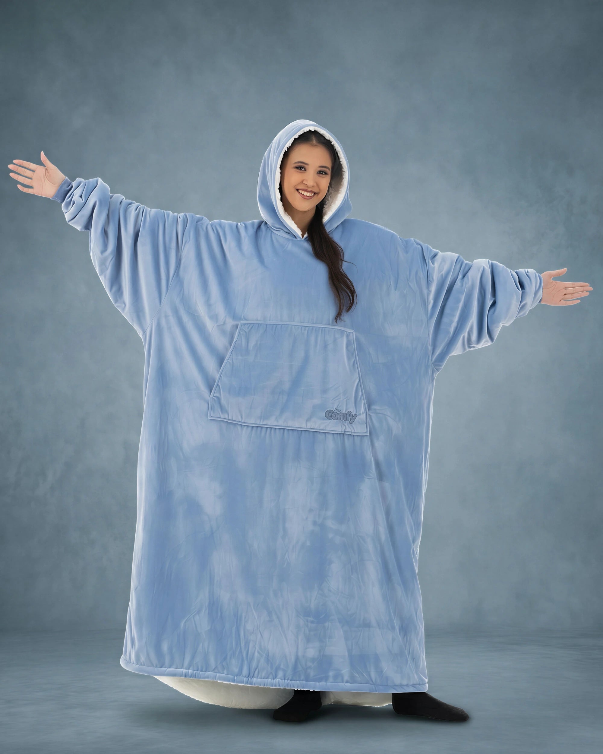Front view of The Original Long in Serenity Blue with arms extended, highlighting the oversized wearable blanket silhouette, roomy sleeves, and full-body comfort.