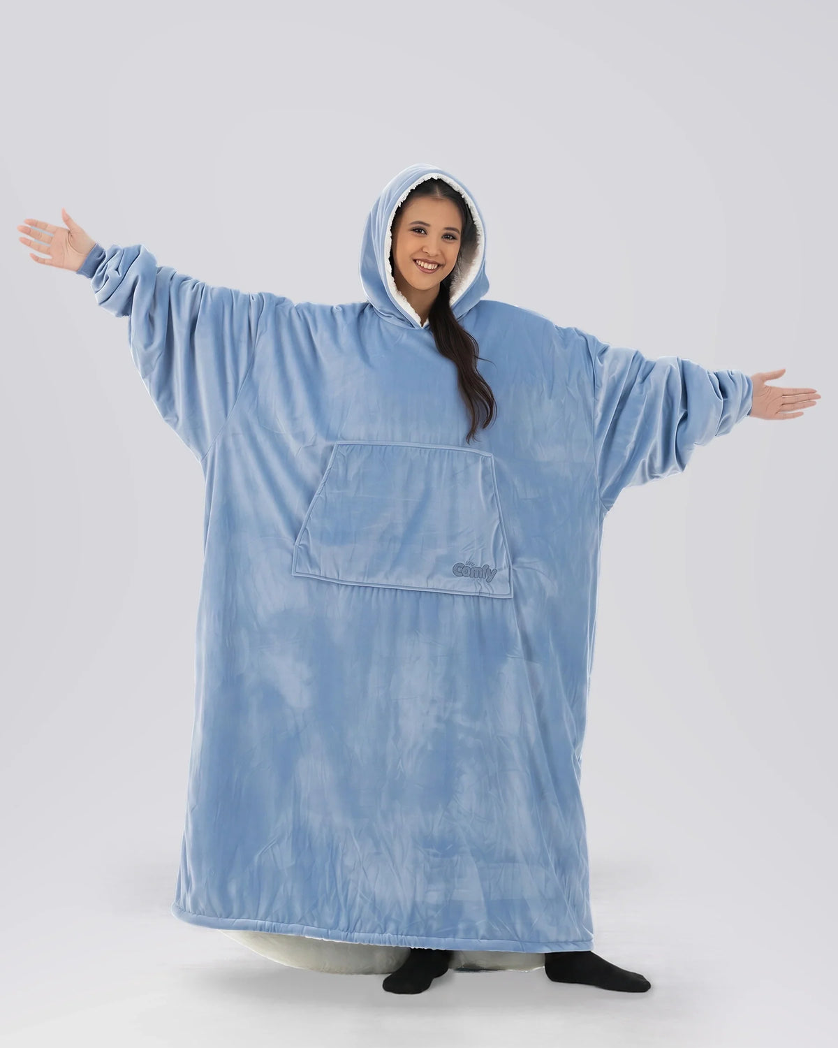 Front view of The Original Long in Serenity Blue with arms extended, highlighting the oversized wearable blanket silhouette, roomy sleeves, and full-body comfort.