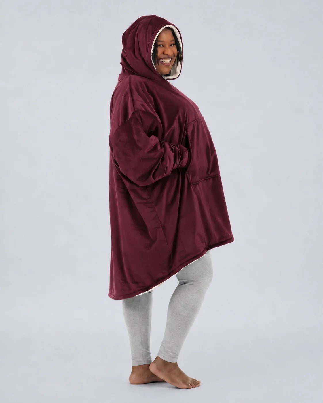 Side view of The Original wearable blanket in burgundy showing oversized fit and hood design