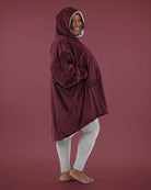 Side view of The Original wearable blanket in burgundy showing oversized fit and hood design