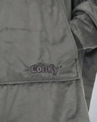 Close-up detail of The Original wearable blanket in charcoal showing Velveluxe™ fabric and embroidered logo