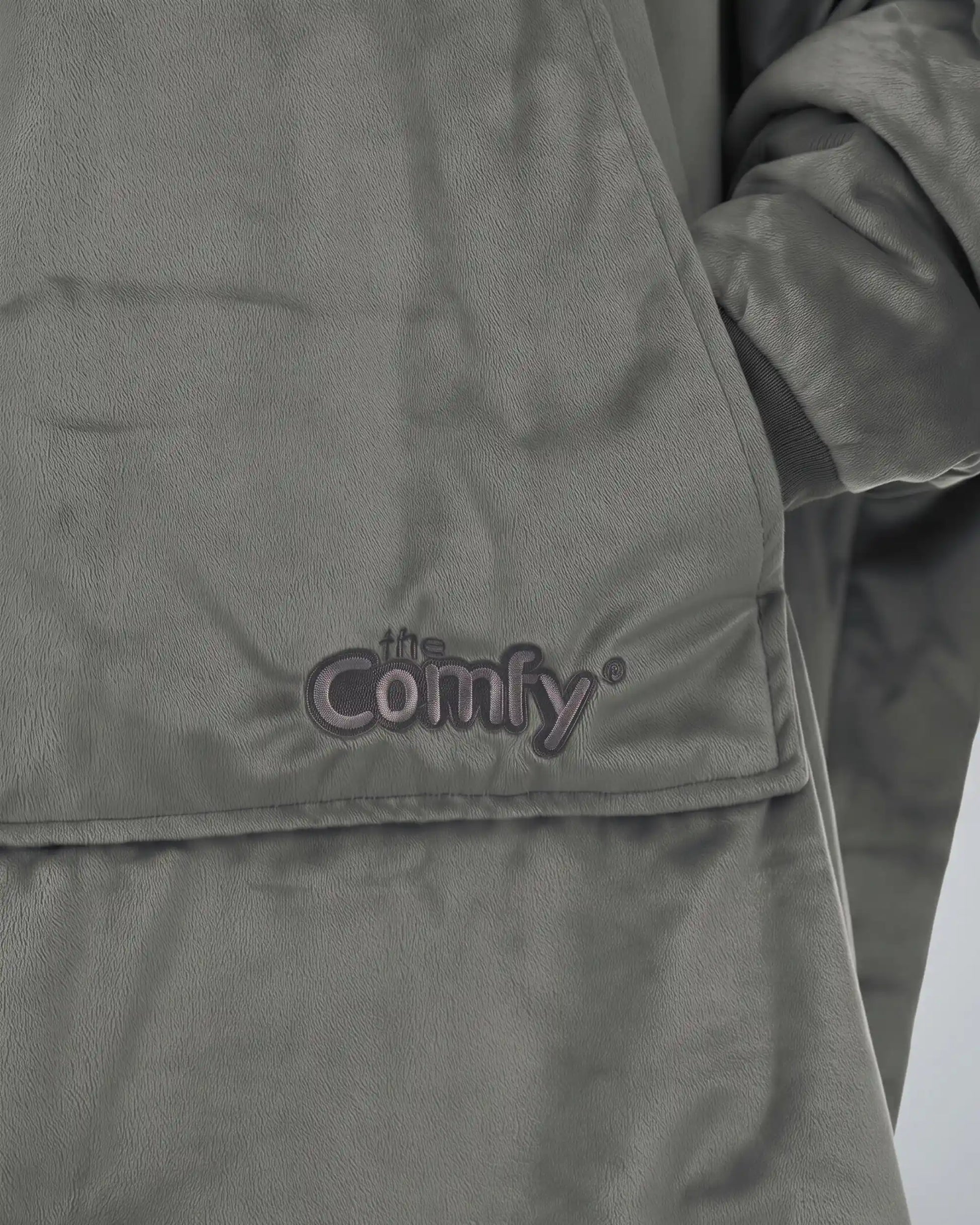 Close-up detail of The Original wearable blanket in charcoal showing Velveluxe™ fabric and embroidered logo