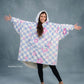 Front-facing hero image of The Original in Flower Checkered, featuring a playful blue-and-white checker pattern with pink floral accents, oversized silhouette, kangaroo pocket, and cozy CloudSherpa™ lining.
