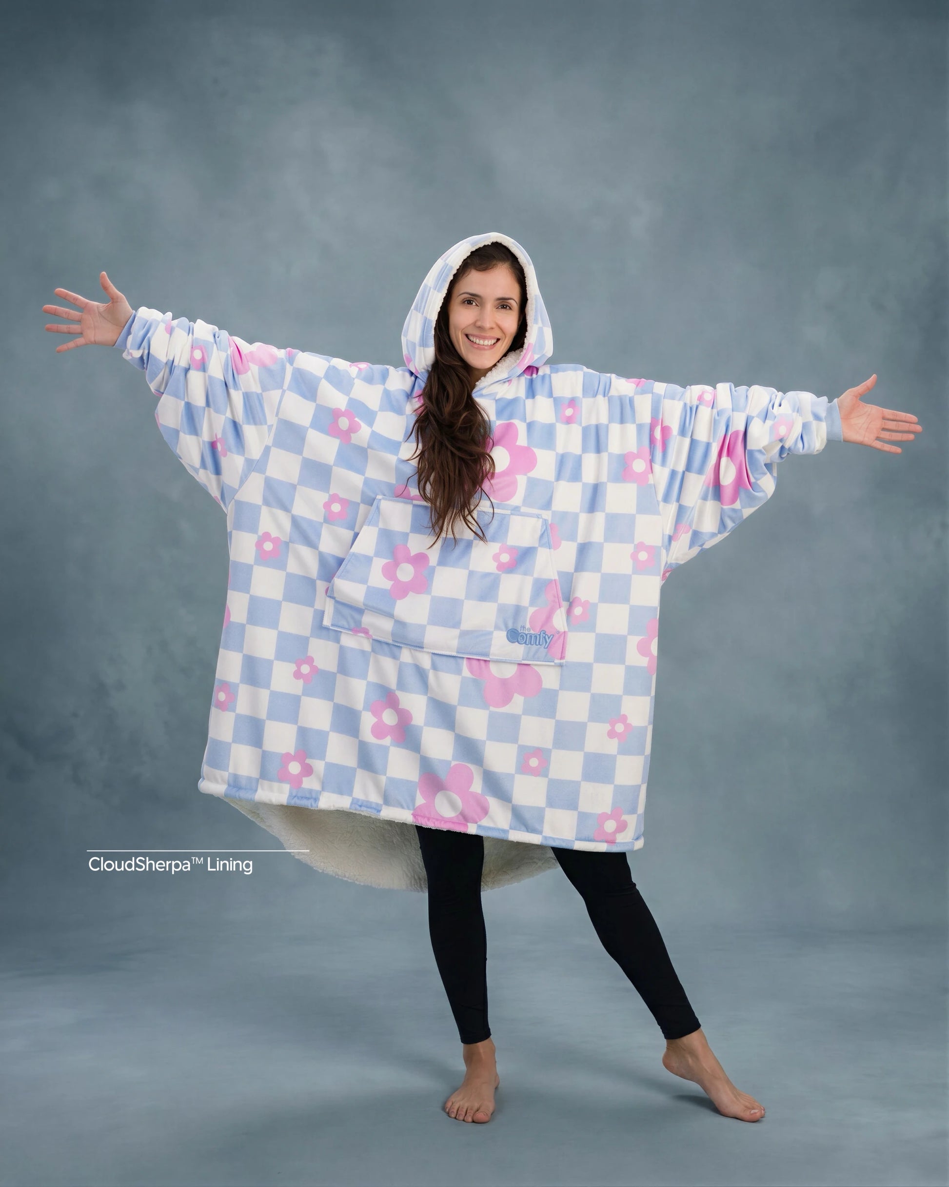 Front-facing hero image of The Original in Flower Checkered, featuring a playful blue-and-white checker pattern with pink floral accents, oversized silhouette, kangaroo pocket, and cozy CloudSherpa™ lining.