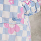 Close-up detail of The Original in Flower Checkered showcasing the premium printed Velveluxe™ fabric, embroidered logo, oversized pocket construction, and soft ribbed cuff.