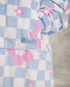 Close-up detail of The Original in Flower Checkered showcasing the premium printed Velveluxe™ fabric, embroidered logo, oversized pocket construction, and soft ribbed cuff.