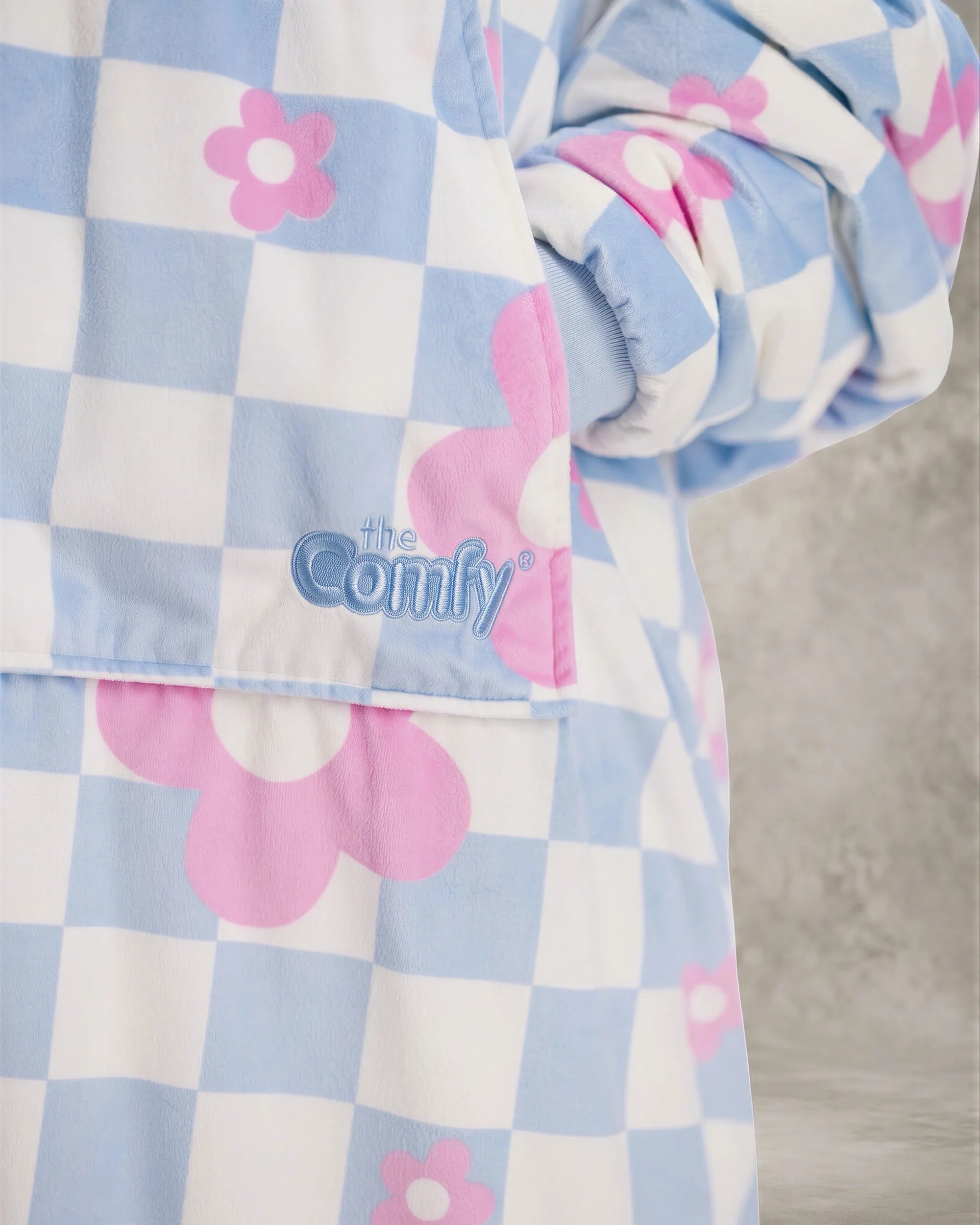 Close-up detail of The Original in Flower Checkered showcasing the premium printed Velveluxe™ fabric, embroidered logo, oversized pocket construction, and soft ribbed cuff.