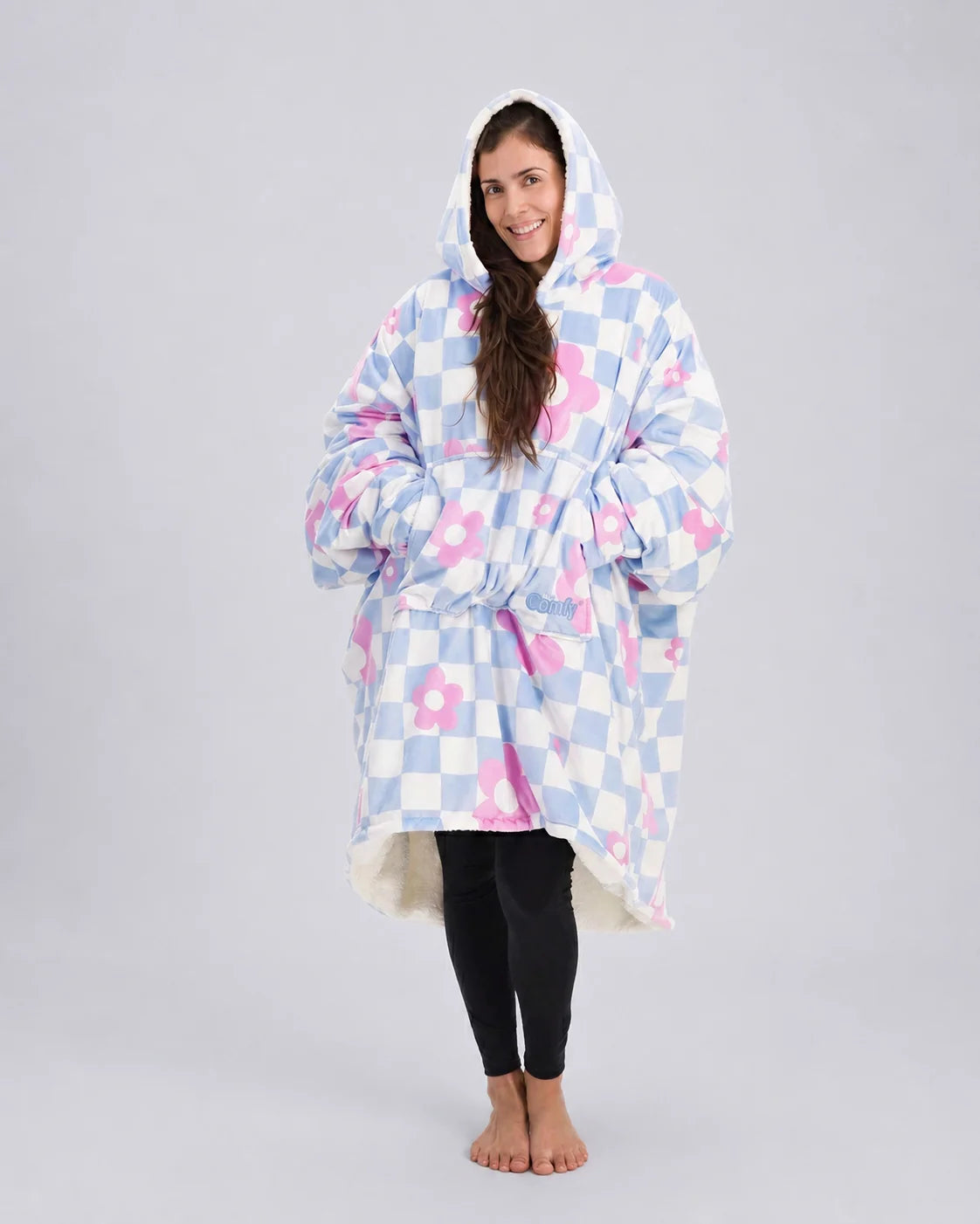 Full-body image of The Original in Flower Checkered with arms extended to demonstrate the signature oversized wearable blanket design, plush CloudSherpa™ lining, and all-day comfort coverage.
