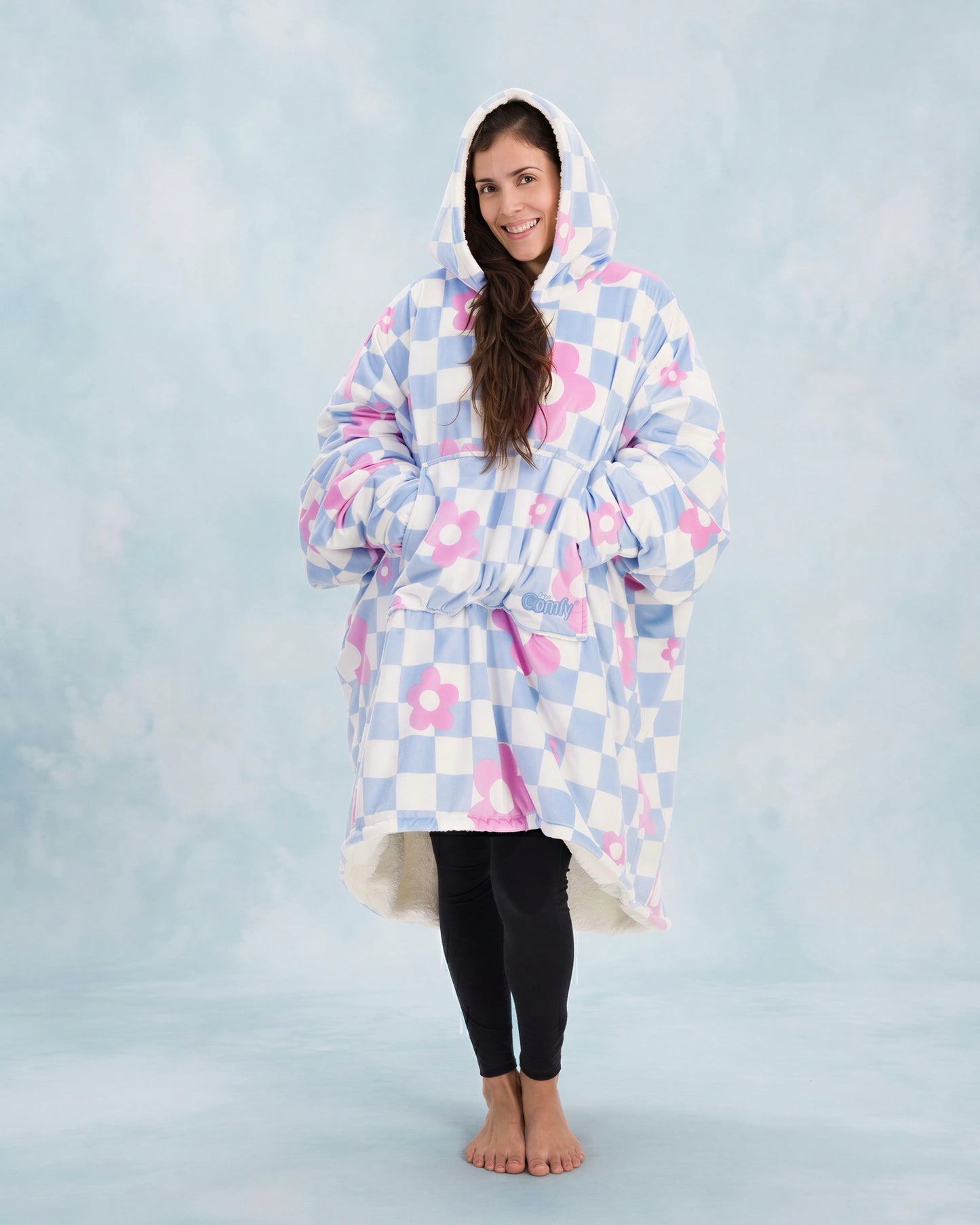 Full-body image of The Original in Flower Checkered with arms extended to demonstrate the signature oversized wearable blanket design, plush CloudSherpa™ lining, and all-day comfort coverage.