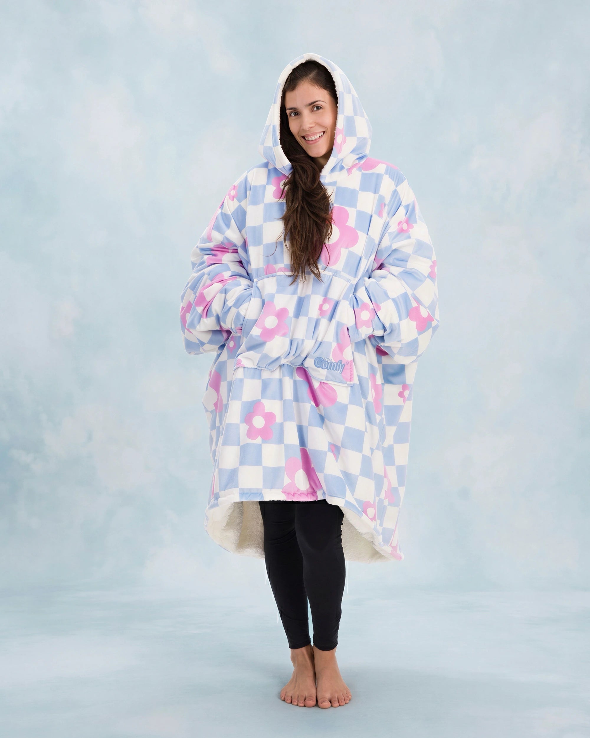 Full-body image of The Original in Flower Checkered with arms extended to demonstrate the signature oversized wearable blanket design, plush CloudSherpa™ lining, and all-day comfort coverage.