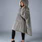 Side view of The Original wearable blanket in gray showing relaxed oversized fit and hood design