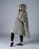 Side view of The Original wearable blanket in gray showing relaxed oversized fit and hood design