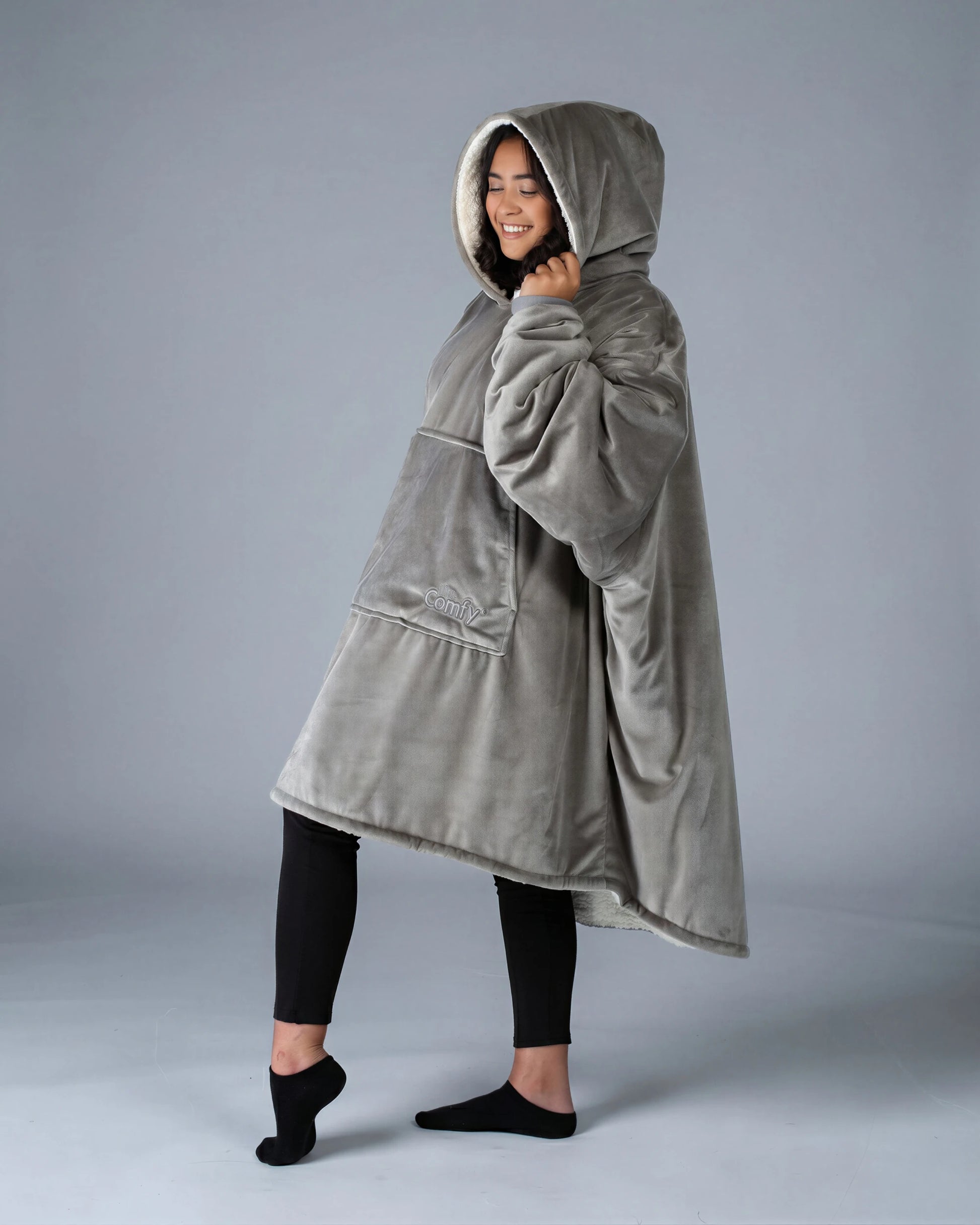 Side view of The Original wearable blanket in gray showing relaxed oversized fit and hood design