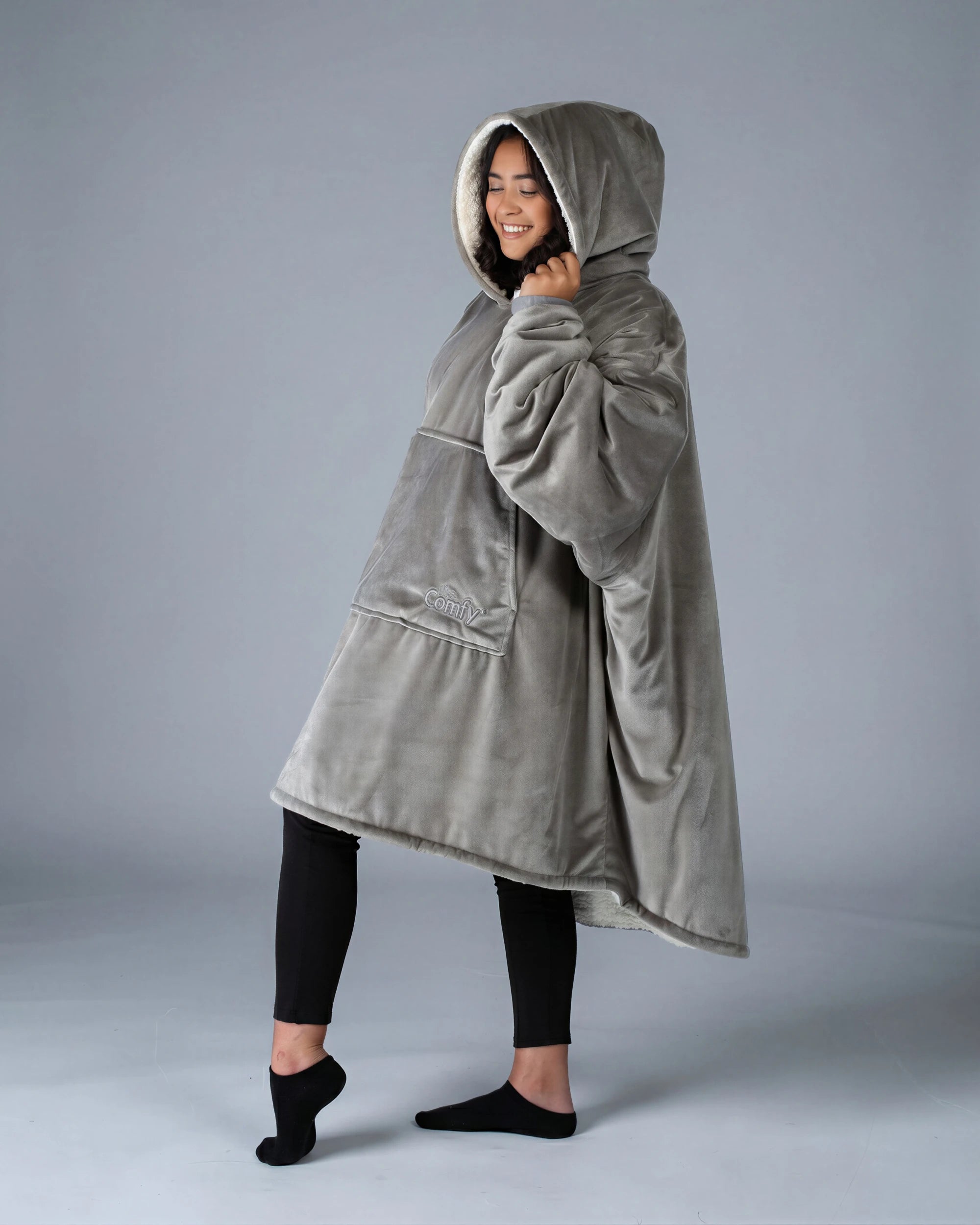 Side view of The Original wearable blanket in gray showing relaxed oversized fit and hood design