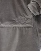 Close-up detail of The Original wearable blanket in gray showing Velveluxe™ fabric and embroidered logo