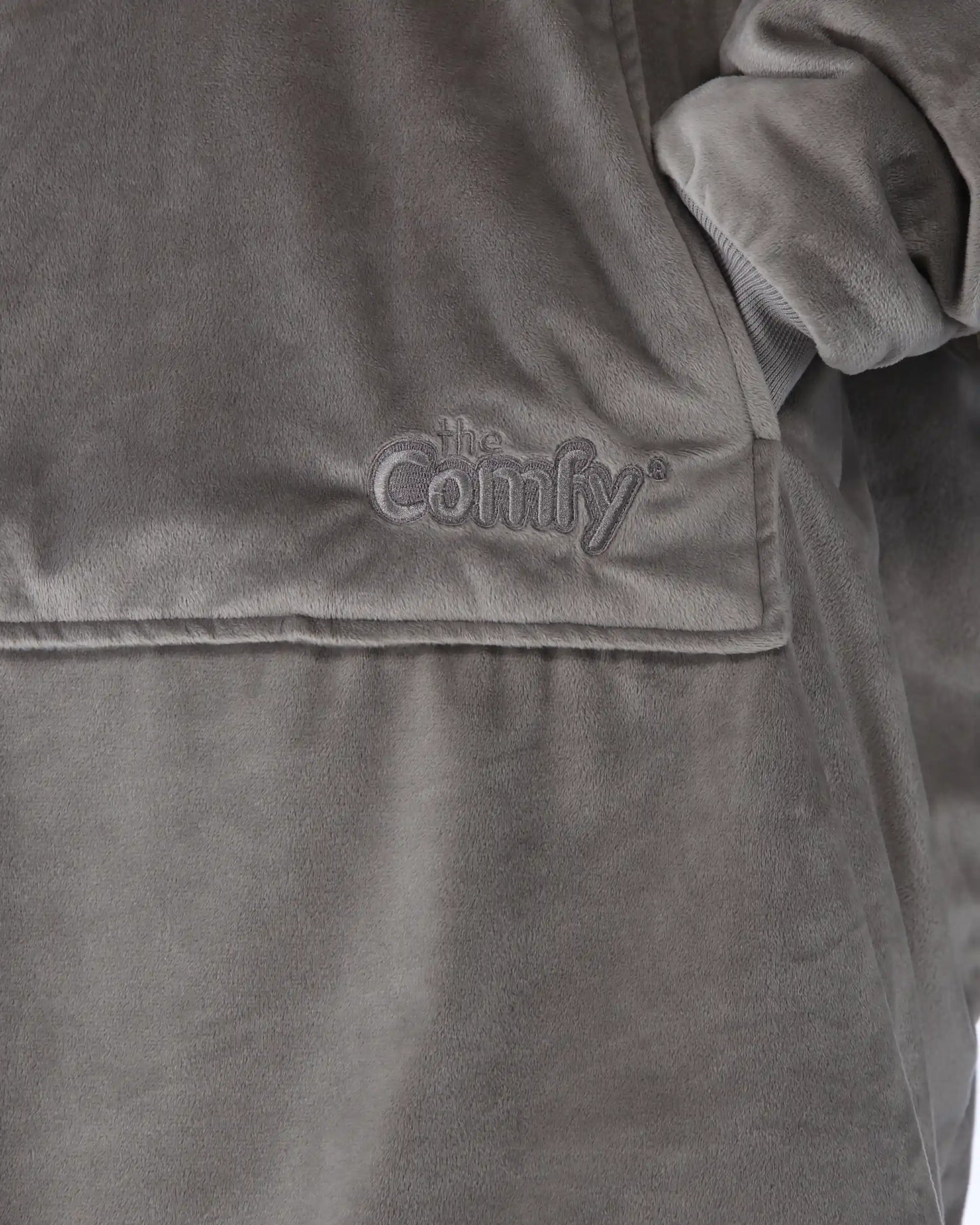 Close-up detail of The Original wearable blanket in gray showing Velveluxe™ fabric and embroidered logo