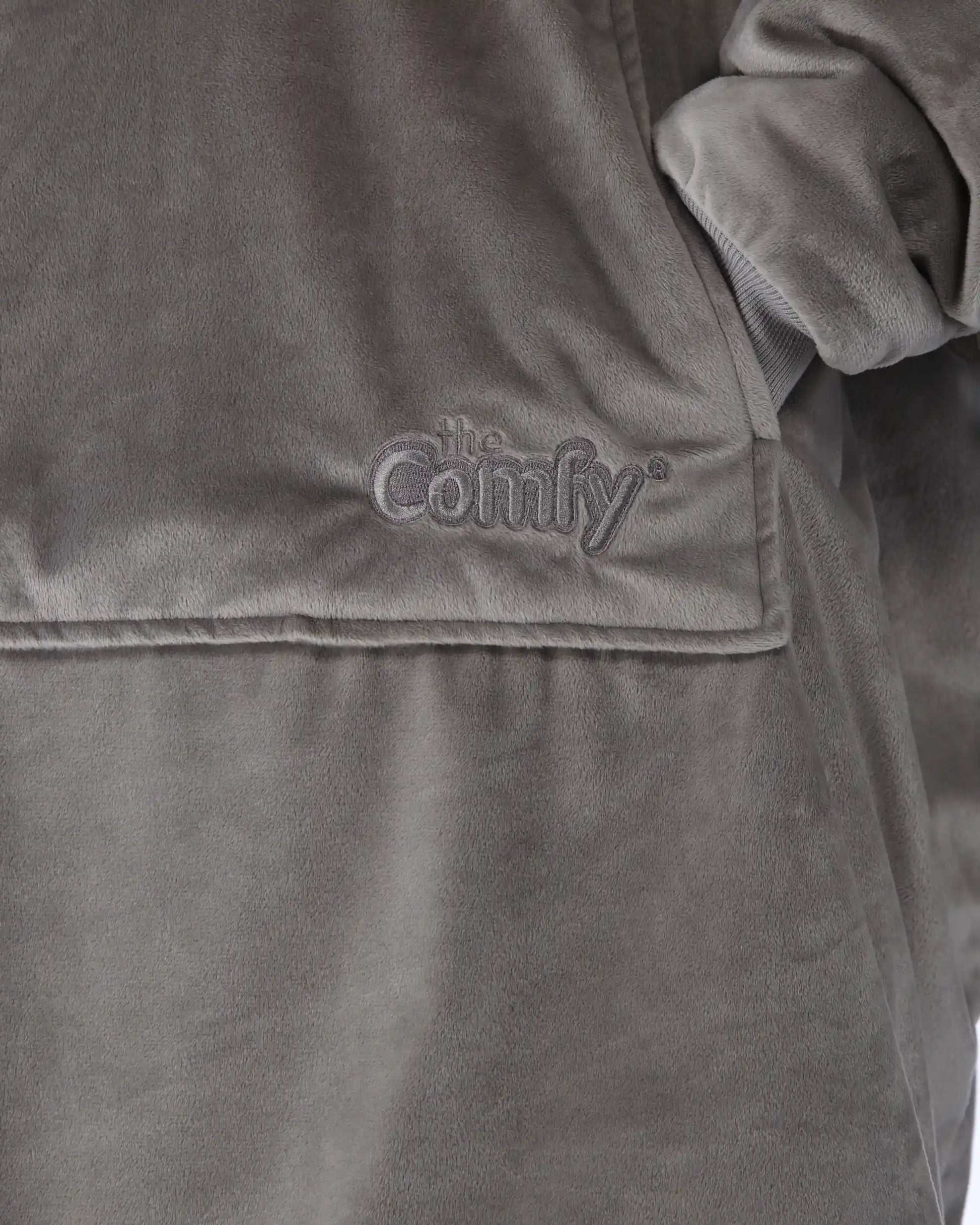 Close-up detail of The Original wearable blanket in gray showing Velveluxe™ fabric and embroidered logo