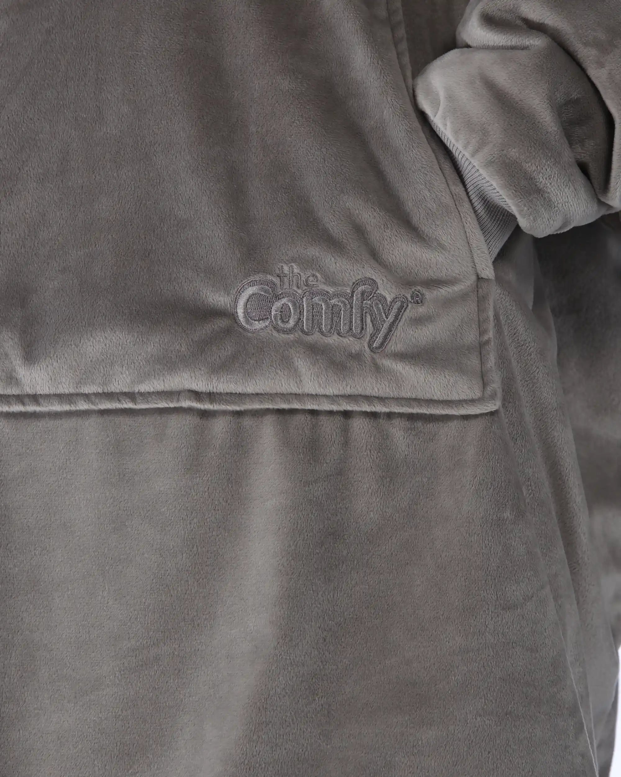 Close-up detail of The Original wearable blanket in gray showing Velveluxe™ fabric and embroidered logo