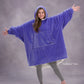 Model wearing The Original in Very Perri Purple with arms outstretched, showcasing the oversized wearable blanket silhouette, kangaroo pocket, and signature CloudSherpa™ lining for maximum comfort and coverage.