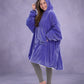 Side-angle view of The Original in Very Perri Purple, highlighting the relaxed oversized fit, roomy hood, and Velveluxe™ exterior designed for cozy comfort at home and beyond.