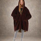 Front view of the Teddy Bear Full-Zip worn on the Chocolate side, featuring the oversized silhouette, hood, and cozy all-over CloudSherpa™ comfort.