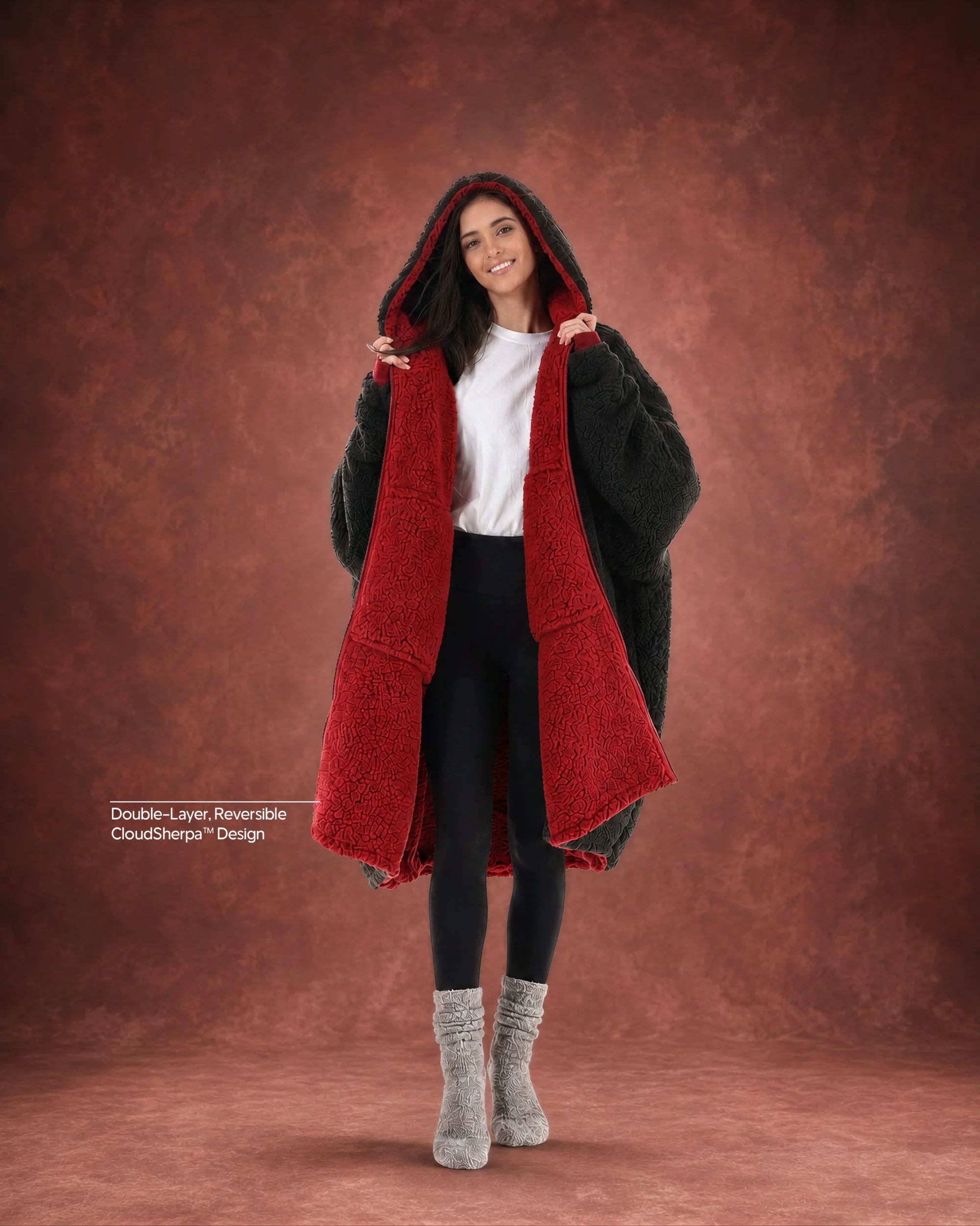 Woman modeling the Teddy Bear Full-Zip in Crimson/Black, showcasing the reversible double-layer CloudSherpa™ design and oversized fit.