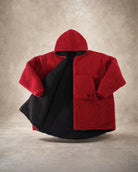 Product flat lay showcasing the Teddy Bear Full-Zip reversed to the Black side, emphasizing dual-sided versatility and premium CloudSherpa™ softness.