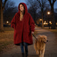 Woman wearing the Teddy Bear Full-Zip in Crimson while walking her dog outdoors, demonstrating warmth and comfort for chilly morning and evening walks.
