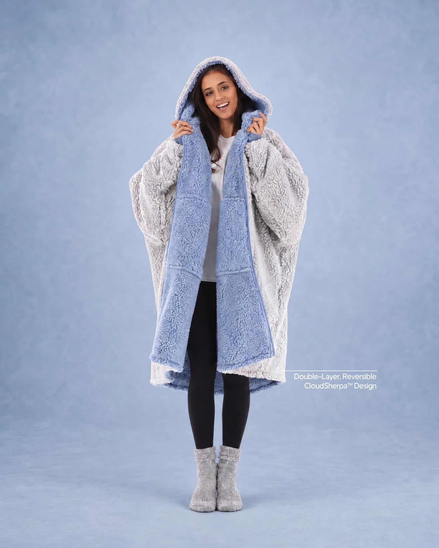 Woman modeling the Teddy Bear Full-Zip in Denim/Light Gray, highlighting the reversible double-layer CloudSherpa™ design and oversized comfort.