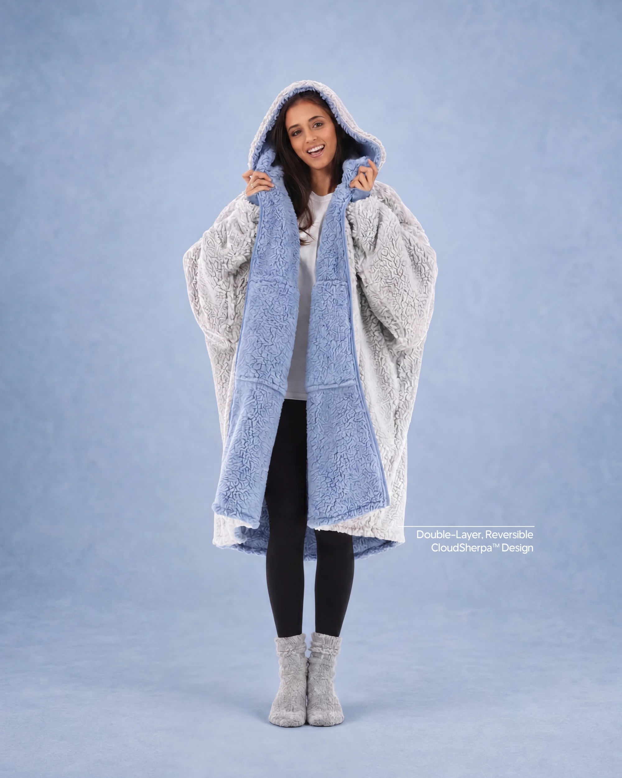 Woman modeling the Teddy Bear Full-Zip in Denim/Light Gray, highlighting the reversible double-layer CloudSherpa™ design and oversized comfort.