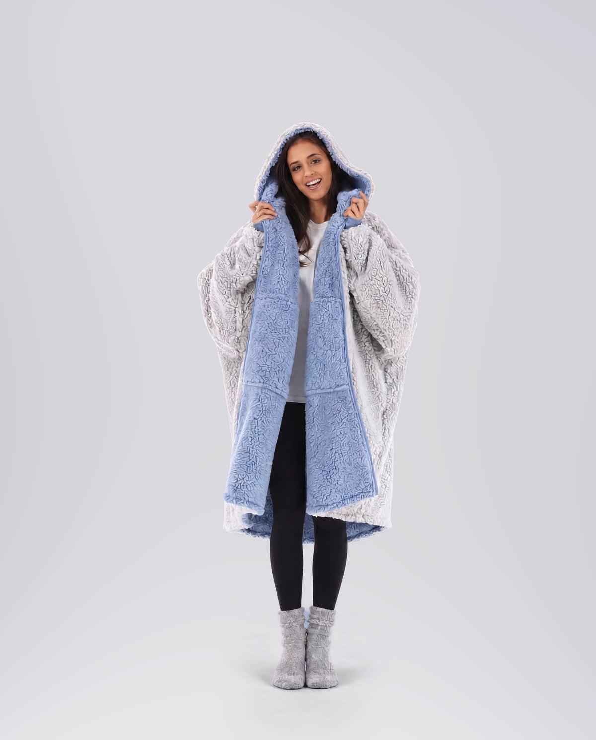 Woman modeling the Teddy Bear Full-Zip in Denim/Light Gray, highlighting the reversible double-layer CloudSherpa™ design and oversized comfort.