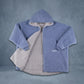 Product flat lay of the Teddy Bear Full-Zip in Denim, featuring reversible double-layer CloudSherpa™, an oversized hood, and full-length zipper.